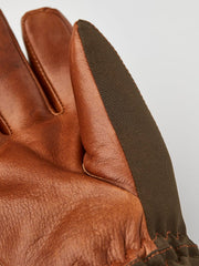 Close-up of brown leather palm and finger seams with dark olive outer panel.