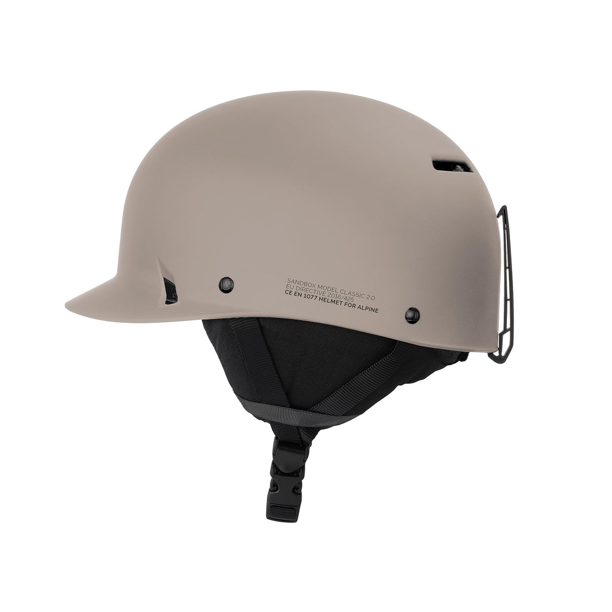 Matte beige snow helmet side profile with vent openings and chin strap.