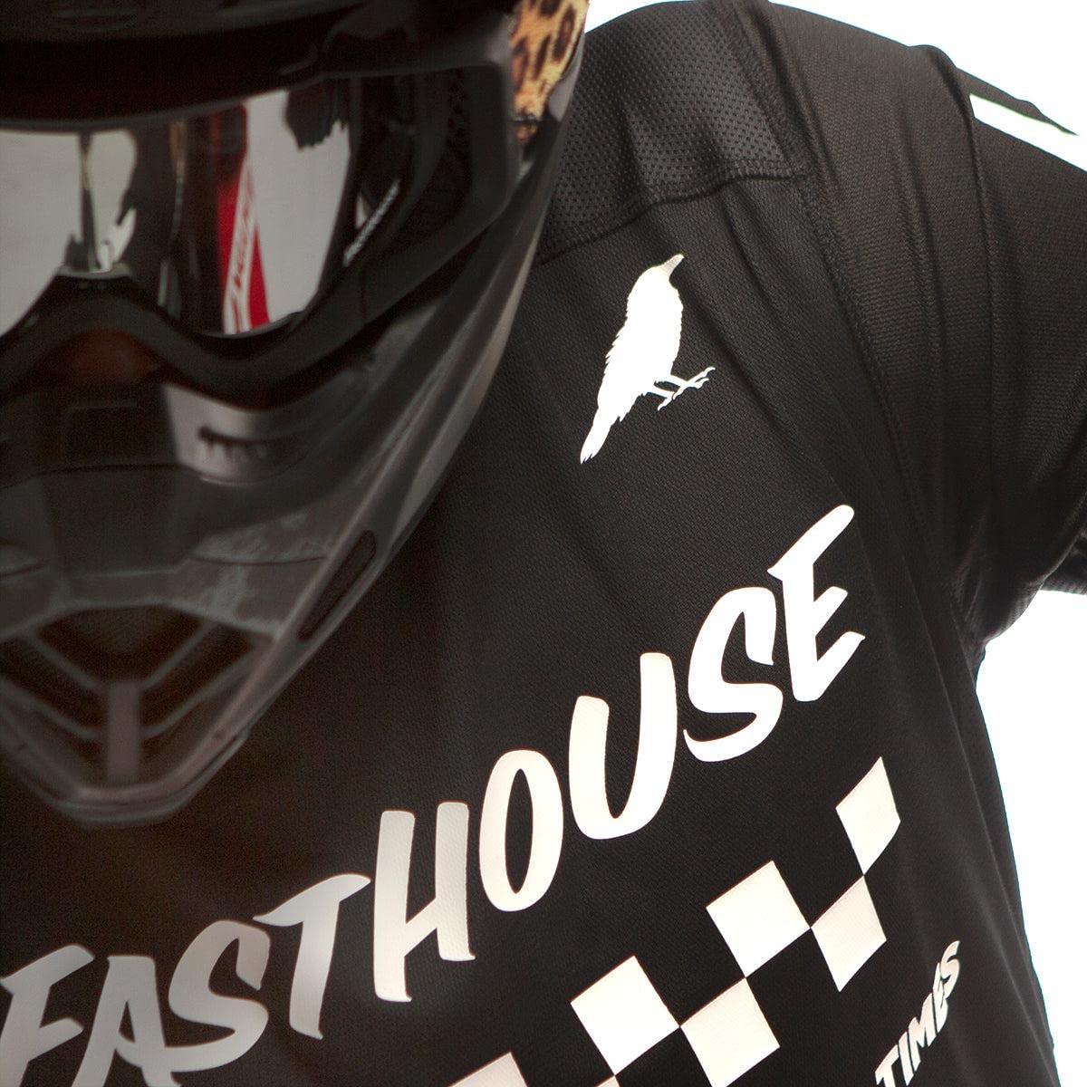 Black long-sleeve motocross jersey chest detail with checkered stripe and text logo