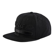 Black snapback hat with Troy Lee Designs logo and embroidered patch