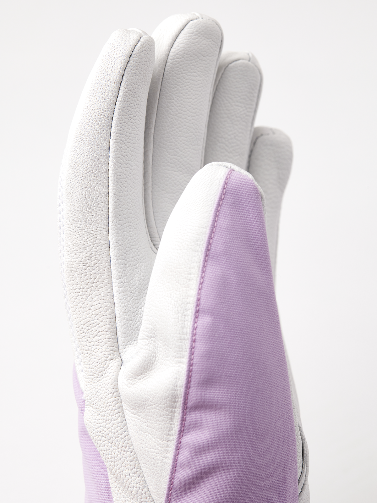 Hestra Heli ski gloves in white with light purple side panels and stitched finger seams