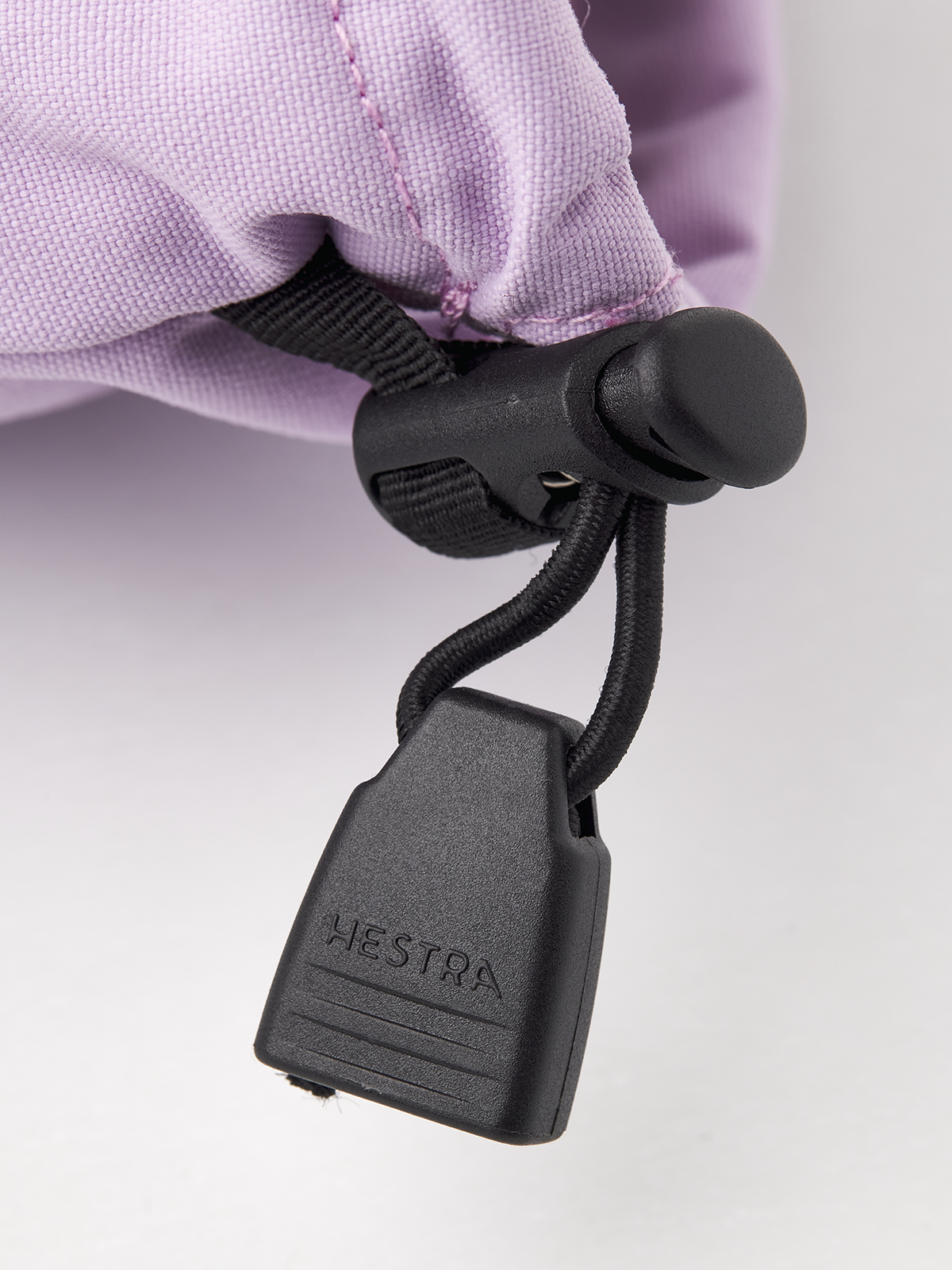 Hestra Heli ski gloves in light purple with black cord loop and plastic tag
