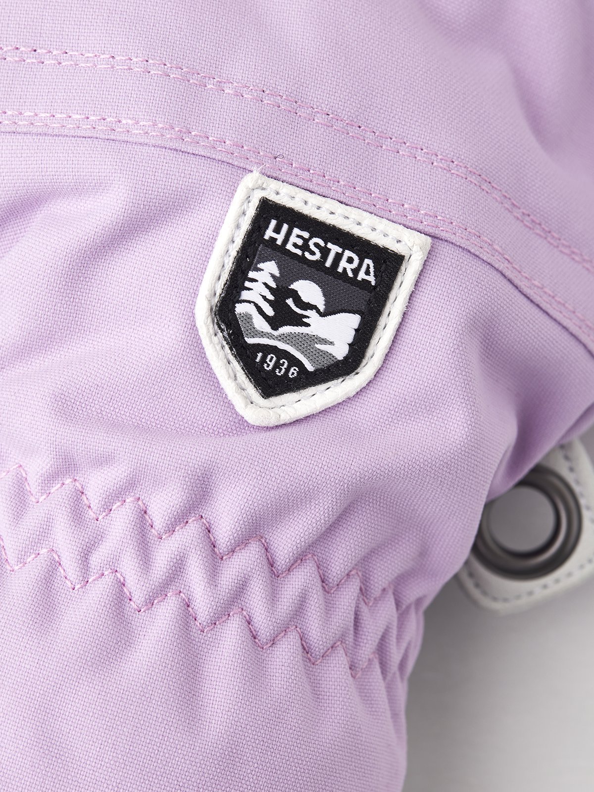 Hestra Heli ski gloves light purple with Hestra logo patch and zigzag cuff stitching