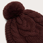 Burgundy knit beanie with oversized pom-pom and cable detail
