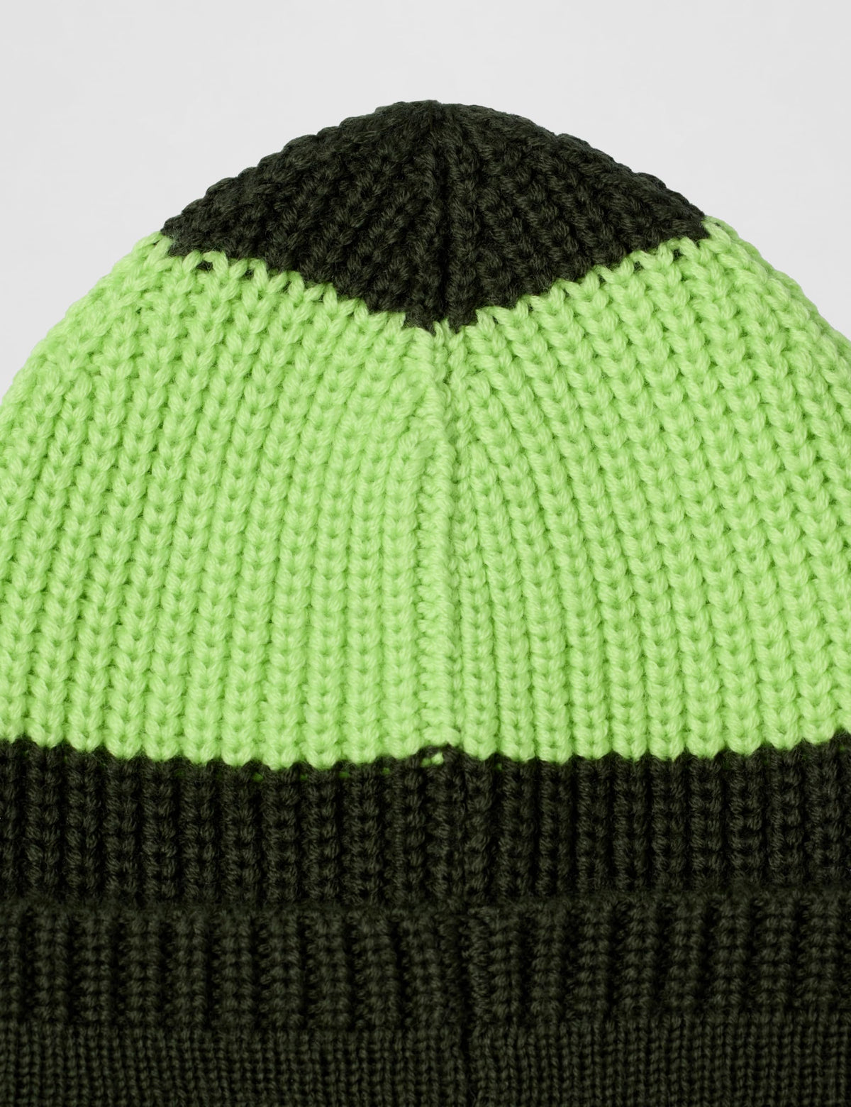Lime green knit beanie with dark green ribbed cuff and rounded crown