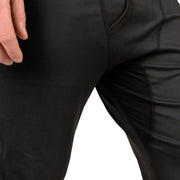 Black baselayer pants fabric close-up with stitched seam lines