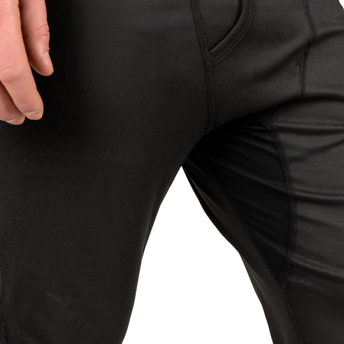 Black baselayer pants fabric close-up with stitched seam lines