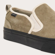 Suede slip-on sneaker with white side strap, tan heel panel, black rubber sole