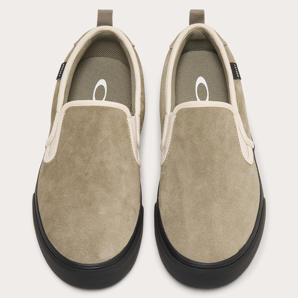 Pair of tan suede slip-on sneakers with elastic gore and black rubber soles
