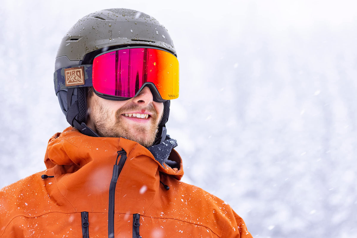 Snow goggles with magenta mirrored lens, GIRO logo on red frame