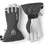 Dark gray and white Hestra leather ski gloves with wrist strap and stitched cuff