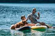 Men’s hooded UV sun shirt worn by swimmer, long sleeves, blue-green camo pattern