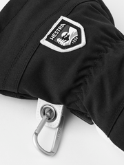 Black ski glove with Hestra patch and metal carabiner loop on the cuff