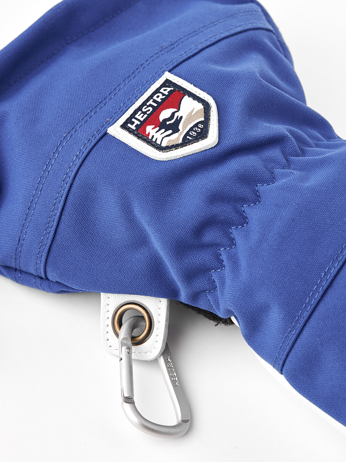 Royal blue ski glove with Hestra patch and metal loop on the cuff