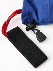 Blue glove cuff with red strap webbing and black pull-tab closure