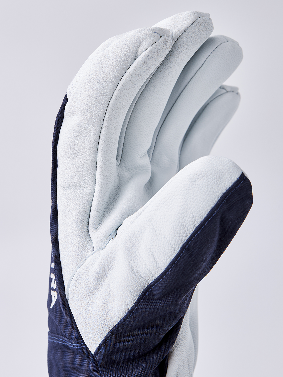 White and light blue ski gloves with navy accent along the cuff