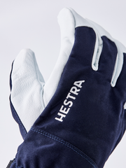 Navy ski glove with white leather panels and HESTRA lettering on cuff