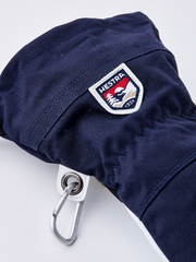 Navy ski glove with Hestra shield patch and metal ring carabiner.