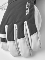Dark gray ski glove with white leather palm and HESTRA logo on back