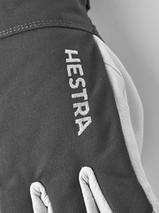 Gray ski glove with vertical HE STRA text on the back of the hand