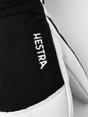 Black Hestra ski glove with white leather trim and HESTRA logo on cuff