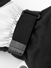 Black Hestra ski mitten cuff with textured strap and stitched leather palm panel