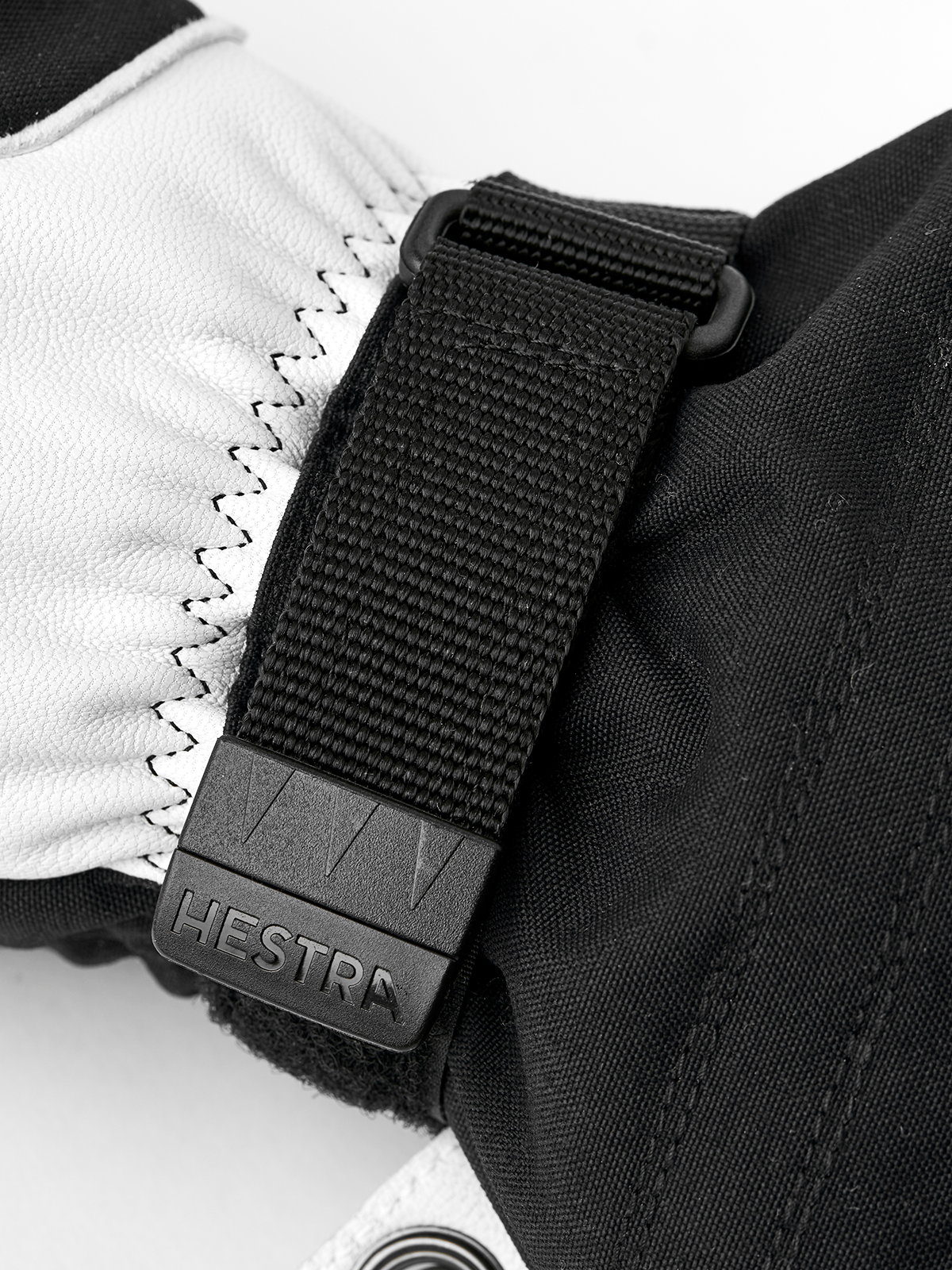Black Hestra ski mitten cuff with textured strap and stitched leather palm panel