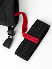 Black Hestra ski glove with red branded hanging loop and black webbing strap
