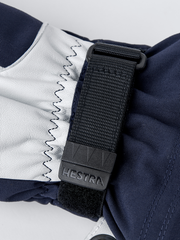 Navy and white Hestra ski mitten cuff with adjustable webbing strap and logo patch