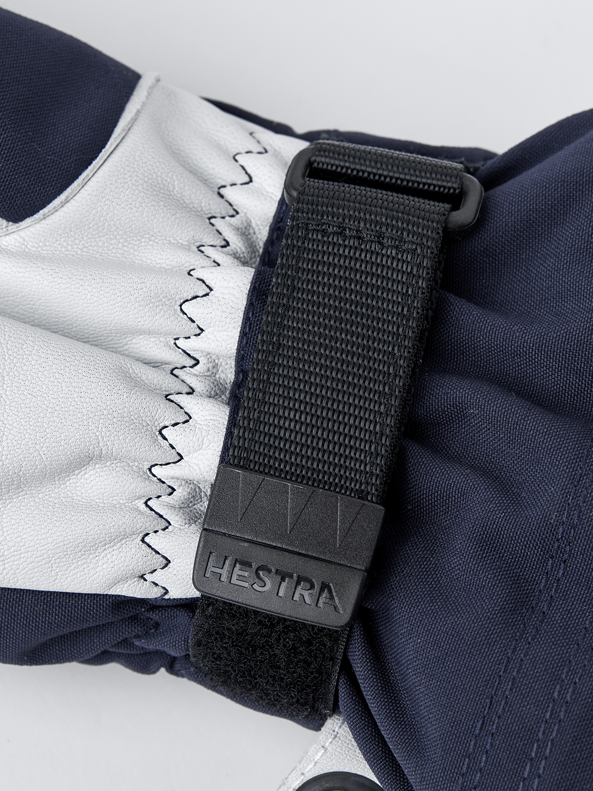 Navy and white Hestra ski mitten cuff with adjustable webbing strap and logo patch