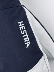 Navy Hestra ski mittens with white leather palm and embroidered logo text