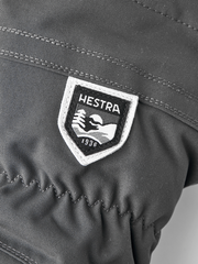 Gray ski mitten with embroidered HESTRA shield logo patch on back panel