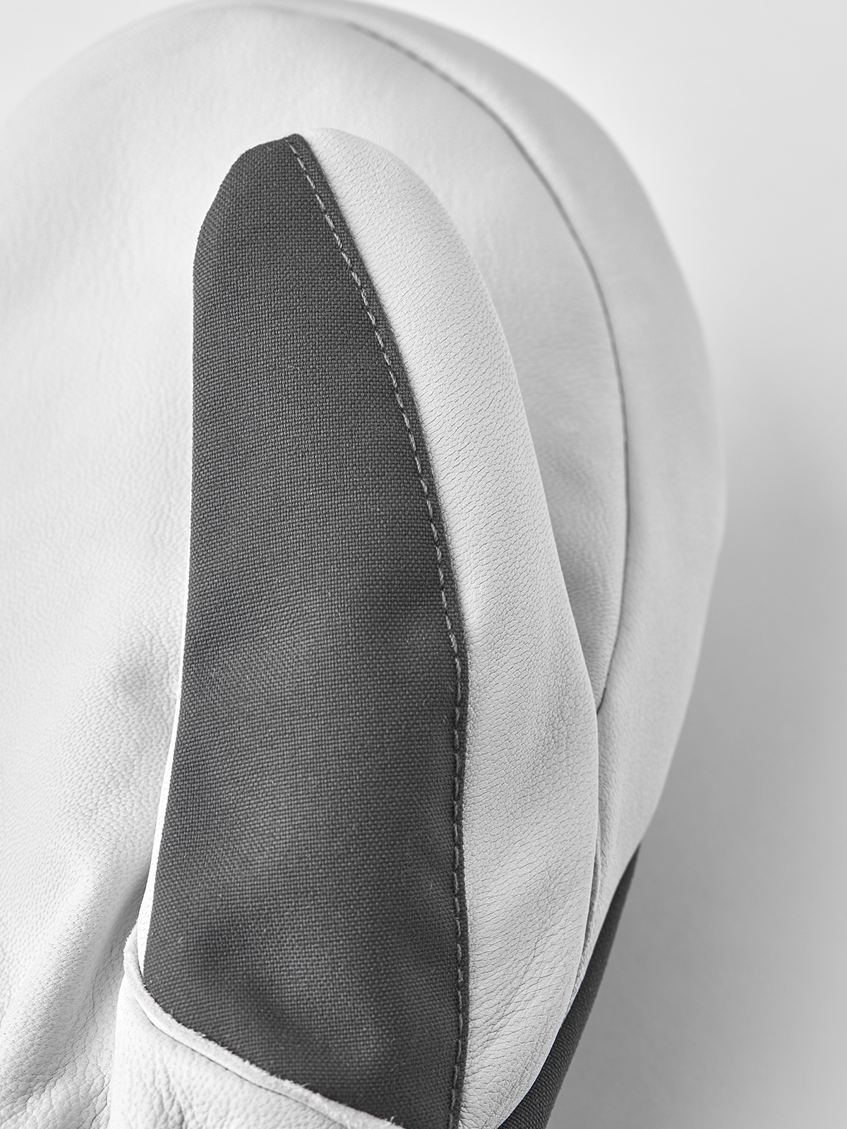 Light gray leather mitten with dark gray side panel and stitched edge