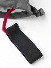 Brown Hestra ski mittens with red lining and black cord lock at wrist