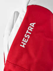 Red ski mitten with white leather cuff and HESTRA logo patch