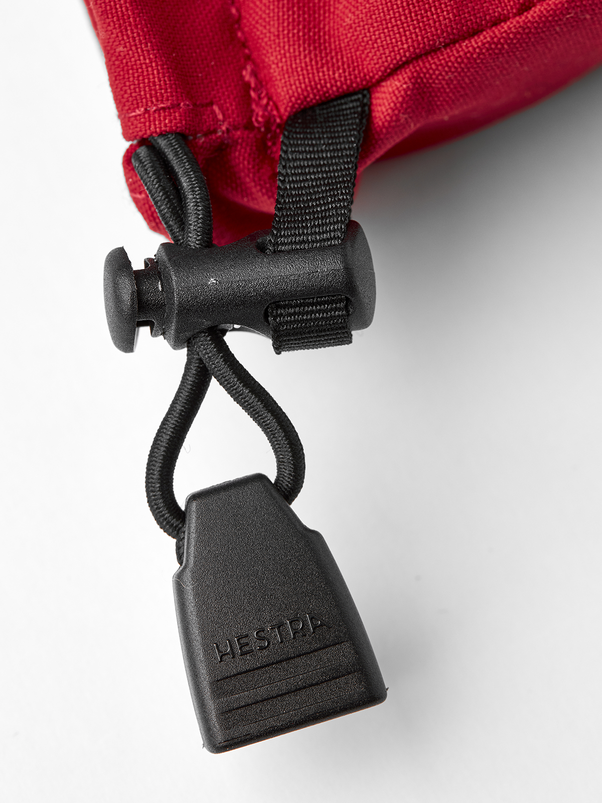 Red ski mitten cuff with black carabiner and locking strap hardware