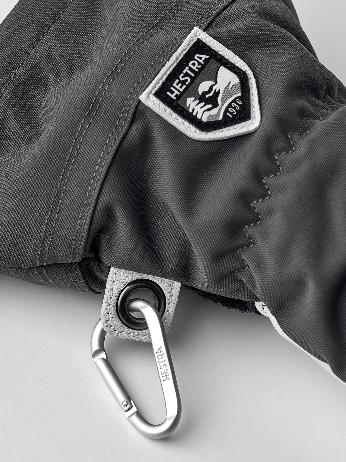 3-finger ski gloves in dark grey with HESTRA logo patch and metal clip.