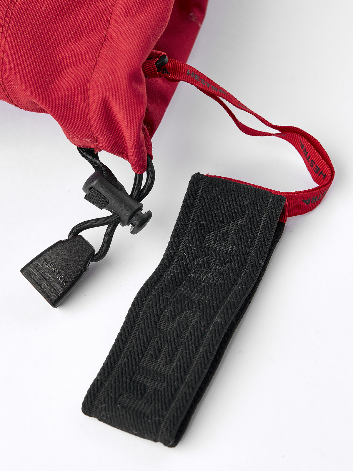 Hestra Army Leather Heli Ski 3-finger gloves in red with black wrist strap and cord