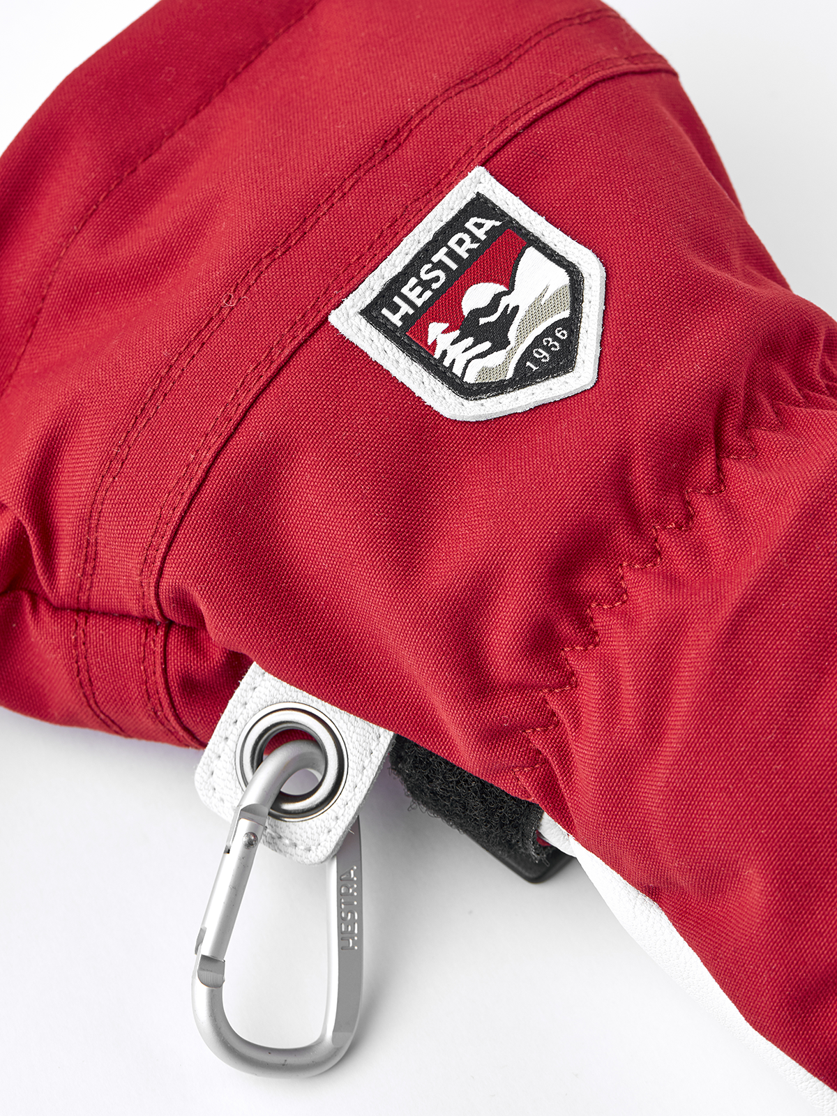 Red Hestra leather ski glove, 3-finger design, logo patch and metal clip detail