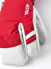 Red and white 3-finger ski gloves with Hestra print on the back of the hand
