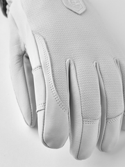 White leather patrol gloves with stitched seams and protective knuckle panel design.