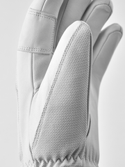 White leather patrol gloves with textured fabric side panel and stitched finger seams.