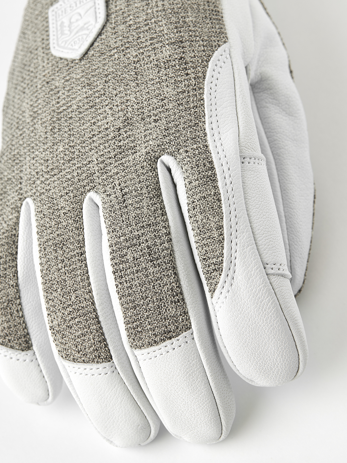 Gray textured fabric patrol glove with white leather fingers and stitched edge trim.