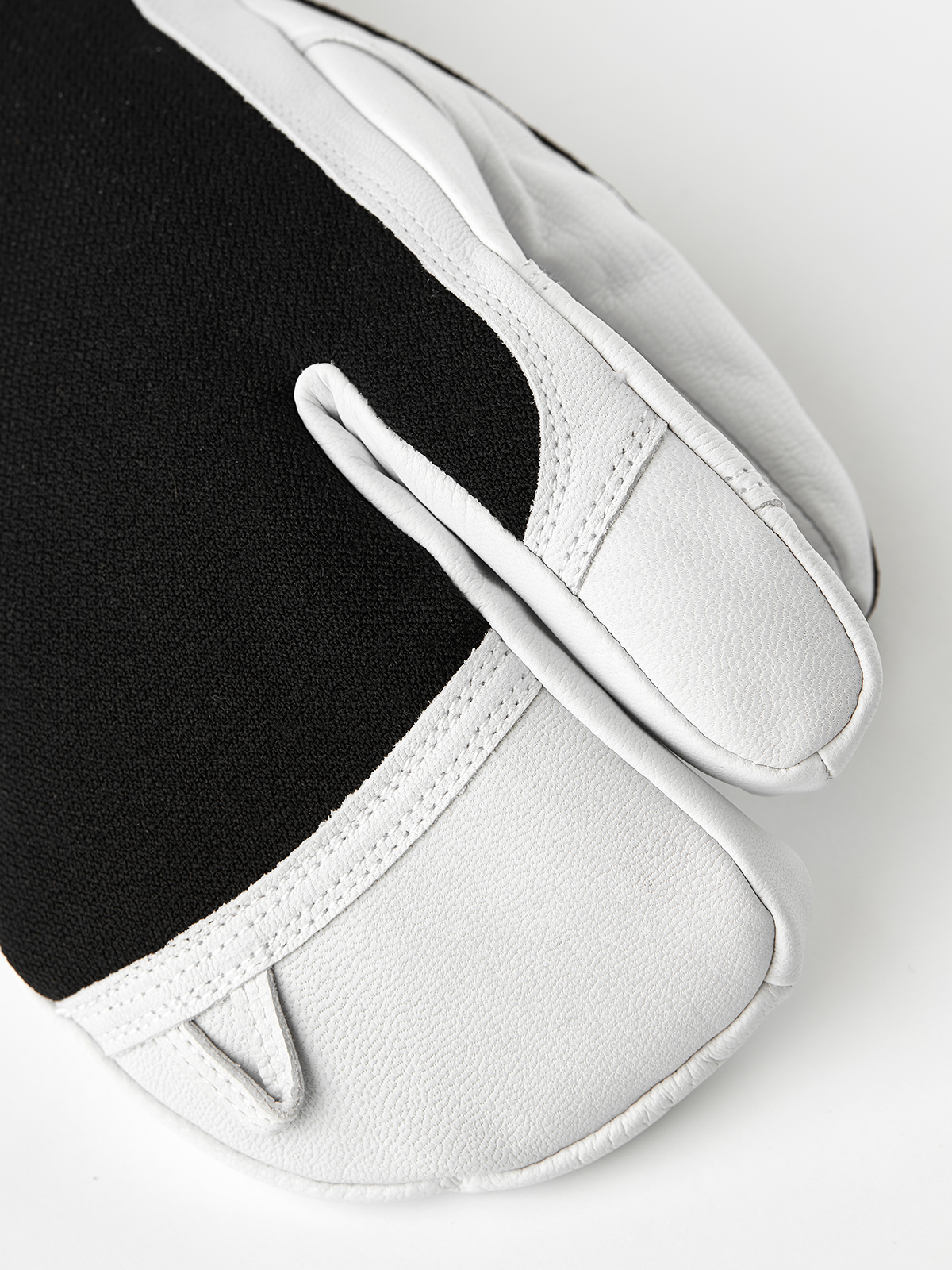 Three-finger leather patrol gloves with black back panel and white fingers, stitched seams