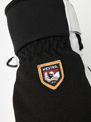 Black patrol glove with Hestra shield patch on knuckle panel.
