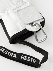 White leather glove with black strap and metal ring/clip at wrist.