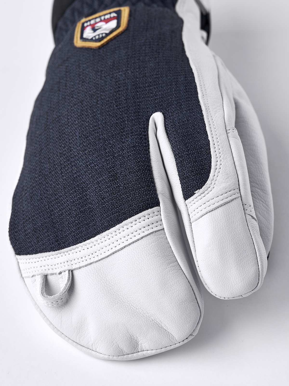 3-finger leather glove in navy with white leather fingers and wrist trim