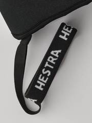 Black wrist strap with 'HESTRA' embroidered lettering on glove.