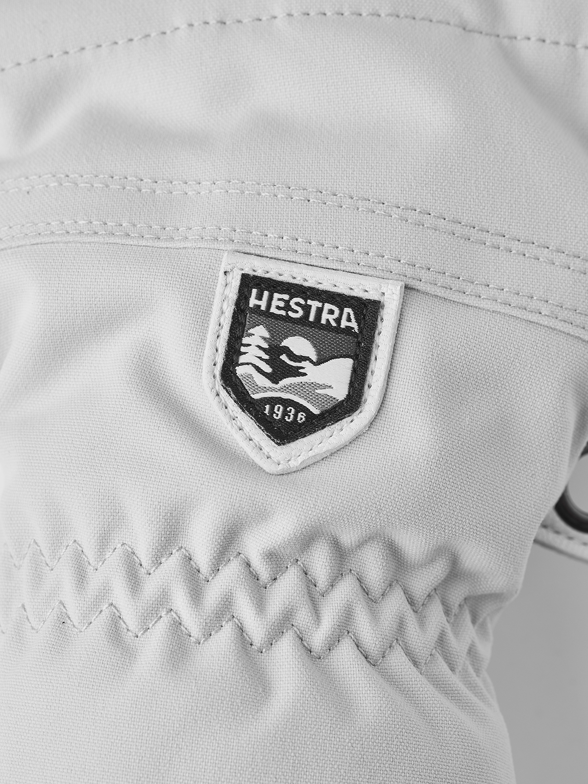 Hestra Heli ski gloves white with HESTRA logo patch on back of hand