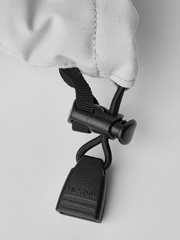 White ski glove with black webbing strap and gray carabiner hook